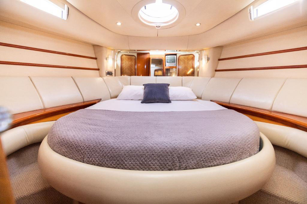 Interior de la cabina de un yate privado con cama y acabados de lujo