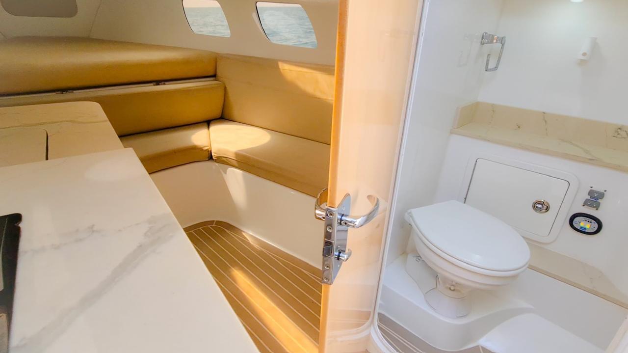 Mini yacht with four outboard motors docked in Cartagena.