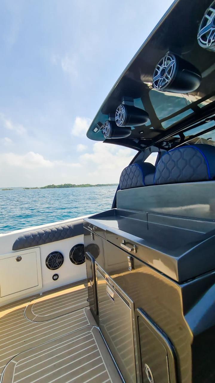 Mini fast yacht leaving Cartagena marina at full speed.