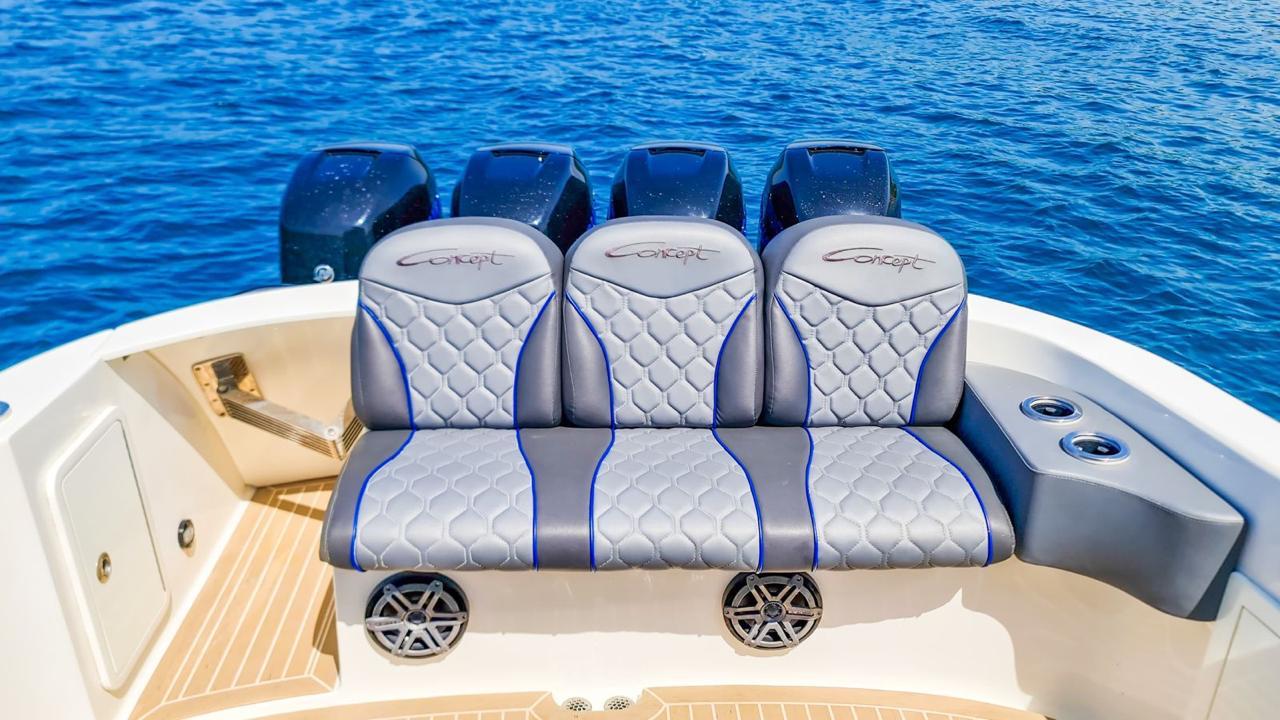 Quad-engine yacht racing through Cartagena Bay waters.