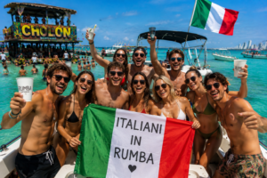 Turisti italiani fanno festa su un party boat a Cholón Cartagena con bandiera italiana, acqua turchese e atmosfera caraibica